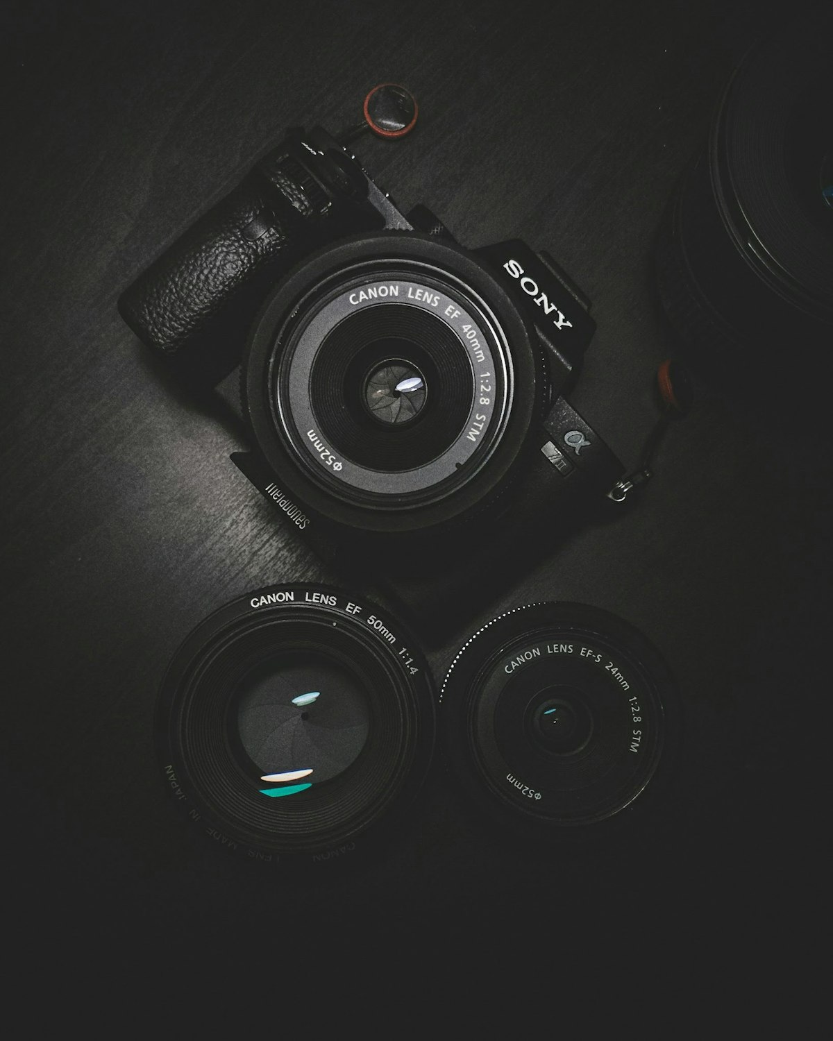 Camera lenses on a desk for photo compression workflows
